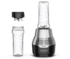 a blender with a glass next to it on a white background and an empty container