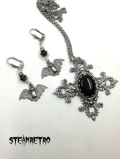 "This fantastic silver plated filigree cross necklace features a Swarovski black jet crystal and is part of our new Dark Gothic range, and is a step away from our previous steampunk work.The set comes complete with our spooky silver plated vampire bat earrings! There are numerous Gothic designers out there, and various marketplaces to purchase Gothic jewellery, but i am sure you will like what we are doing here Growing up in the 80's i lived through the \"goth\" movement, many a lost weekend was Silver Cross Jewelry For Halloween, Gothic Cross Pendant Jewelry For Halloween, Gothic Cross Jewelry For Gifts, Gothic Cross Jewelry As Gift, Gothic Cross Jewelry Gift, Halloween Silver Jewelry With Cross Pendant, Silver Cross Pendant Jewelry For Halloween, Gothic Nickel-free Cross Jewelry, Black Cross Pendant Jewelry For Halloween