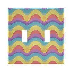 a light switch cover with an abstract wave design in pastel blue, yellow and pink