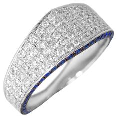 Elegant 18kt white gold ring with diamond pavé and sapphires on the edges from Ralph Masri's Modernist collection, inspired by mid-century Modernist architecture with an emphasis on minimalist shapes and silhouettes. Available in white, yellow or rose gold. Can be made in any ring size. Luxury Sapphire Ring With Diamond Channel Set, Platinum Sapphire Ring With Pave Setting In White Gold, Luxury White Gold Sapphire Ring Channel Set, Modern Sapphire Ring In Platinum With Brilliant Cut, Formal Sapphire Ring With Pave Setting In Diamond White, Modern Platinum Sapphire Ring With Brilliant Cut, Formal Platinum Sapphire Ring With Pave Setting, Sapphire Diamond Ring With Pave Setting In White Gold, White Gold Sapphire Diamond Ring With Pave Setting