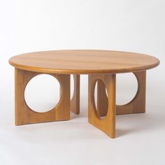 a wooden table with two circular holes in the middle