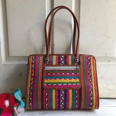 This trendy artisan bag is a perfect accessory that will make you stand out amongothers on the beach or market. Removable tassel bag charm included. Perfect for adding a touch of color for your bags and purses. Tassel also great as key-chains, rear view mirror accessories, door knob decorations, etc. MADE IN MEXICO By: Mexican Artisans Size: Medium Color: Multi Dimensions: 14 x 11 x 3.5 Details: Style: Top-handle | shoulder bag Material: palm leaf Synthetic leather handles: 11.5" Drop Zipper clo Bohemian Multicolor Travel Satchel, Vibrant Rectangular Travel Bag, Bohemian Multicolor Satchel For Everyday Use, Vibrant Colorful Shoulder Bag For Everyday Use, Colorful Handwoven Shoulder Bag For Travel, Artisan Multicolor Travel Satchel, Rectangular Satchel With Tassels, Rectangular Travel Satchel With Tassels, Colorful Travel Satchel Tote