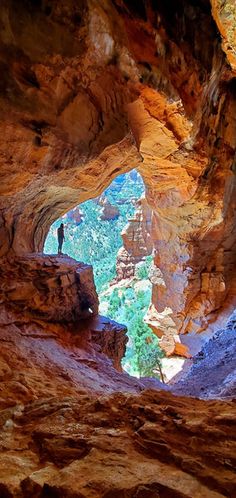 a person standing in the middle of a cave