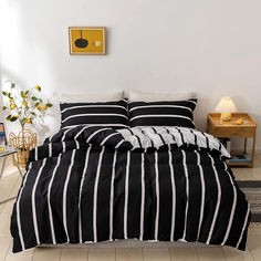 a black and white striped comforter on a bed