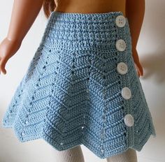 there is a crocheted skirt on the back of a doll