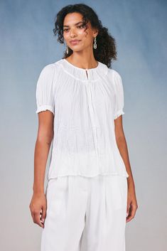 With its flowy shape and crinkle texture, this short-sleeve pleated top is just the right piece for creating effortlessly chic looks. It's softly textured and floats elegantly on the figure, drawn in by delicate ruffle trim. •Relaxed fit •Pullover styling •Cuffs Item number 2430190 100% Polyester Chic Textured Short Sleeve Tops, Chic Short Sleeve Textured Tops, Chic White Blouse With Crinkle Texture, Textured Short Sleeve Blouse For Summer, Textured Short Sleeve Summer Blouse, White Crinkle Texture Blouse, Relaxed Fit Tops With Crinkle Texture And Short Sleeves, Chic Short Sleeve Blouse With Crinkle Texture, Chic Crinkle Texture Blouse For Daywear