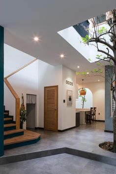 the inside of a house with stairs leading up to an open floor plan and wooden door