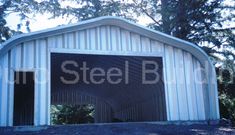 an image of a steel building with trees in the background