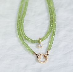 "This necklace is available as a regular 16-18\" piece with clasp and extender or as a strand with open jump rings [to wear with a carabiner style clasp] Peridot opens our hearts to joy and new relationships. It enhances confidence and assertion, motivating growth and change D E T A I L S △ Handmade in Vancouver △ Option 1: 14k gold filled clasp and extender 16-18\" △ Option 2: Strand with open jump rings 16\" [white topaz carabiner not included] △ Faceted rondel cut genuine peridot 3-4mm △ Gemstones are 100% genuine  White topaz pendant add on available here: www.etsy.com/ca/listing/1538766506 White topaz carabiner: www.etsy.com/ca/listing/1539373762 All carabiners and pendants:  https://www.etsy.com/ca/shop/EarthlyAbundanceGems?ref=seller-platform-mcnav§ion_id=33816756 Q U A L I T Y  The Green Peridot Necklace For May Birthstone, Round Peridot Birthstone Necklace, Lime Green Peridot Necklace For May Birthstone, Anniversary Peridot Birthstone Necklace, Lime Green Peridot Jewelry For May Birthstone, Peridot Faceted Jewelry For May Birthstone, Faceted Peridot Jewelry For May Birthstone, Peridot Gemstone Necklace For May Birthstone, Green Peridot Gemstone Necklace