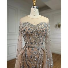 a dress on a mannequin with silver sequins and beaded detailing