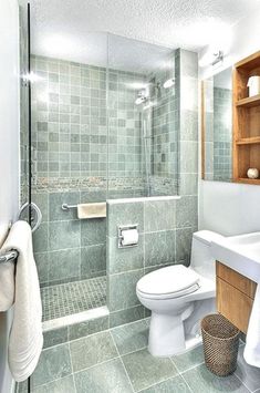 a bathroom with a toilet, sink and shower