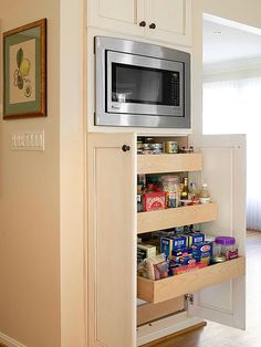 a microwave is built into the side of a cabinet