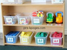 a wooden shelf with plastic containers and toys on it