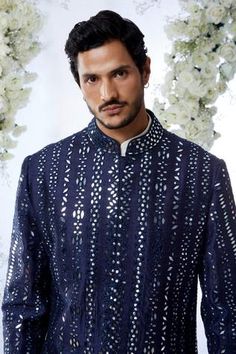 Midnight sherwani features all-over mirror work on a raw silk base. Paired with an off-white cotton kurta and a afghani cotton silk salwar.
Components:3
Pattern:Embroidered
Type of Work:Mirror Work
Neckline:Mandarin
Sleeve Length:Full Sleeves
Fabric:Raw Silk
Color:Blue
Other Details:
Mirror work
Note: Pocket square worn by the model is not for sale
Occasion:Sangeet - Aza Fashions Designer Ceremonial Kurta With Mirror Work, Designer Nehru Jacket With Mirror Work For Festive Season, Designer Nehru Jacket With Mirror Work For Eid, Designer Nehru Jacket With Mirror Work For Festivals, Designer Kurta With Mirror Work For Festive Occasions, Designer Festive Kurta With Mirror Work, Bandhgala With Mirror Work For Diwali, Diwali Bandhgala With Mirror Work Straight Kurta, Designer Nehru Jacket With Mirror Work For Diwali