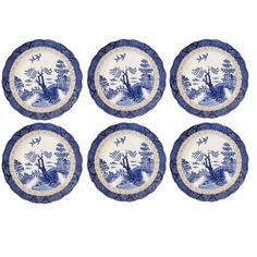 six blue and white plates with trees on them