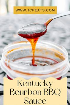 kentucky bourbon bbq sauce is being poured into a glass jar with the words kentucky bourbon bbq sauce on it