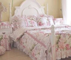 a bedroom with pink flowers and white furniture