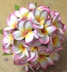 a bouquet of pink and white flowers on a table