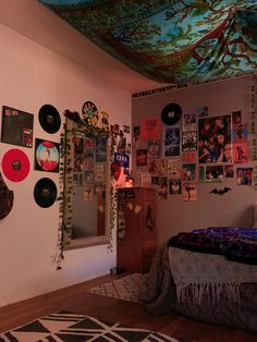 a bed room with a neatly made bed and lots of pictures on the wall