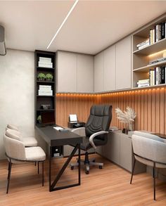 an office with two chairs and a desk in the corner, along with bookshelves