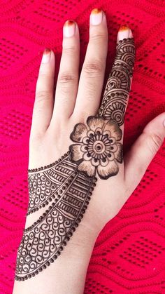 a woman's hand is decorated with hennap and flower designs on it