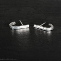 These small silver earrings are handmade by me, one pair at a time in the Pacific Northwest of North America. SIZE: 17mm high x 2mm wide. The space from the post to bottom of the ear lobe is about 9mm. Please measure your ear lobe and hole distance to see how they fit your ear. I strive to run and ecologically sustainable business. Read more about me and my shop here: https://www.etsy.com/shop/SharonSaintDon?ref=l2-shop-header-avatar#about Because my jewelry is made using hand fabrication proces Modern Silver Wrap Earrings As A Gift, Everyday Minimalist Silver Wrap Earrings, Minimalist Silver Wrap Earrings For Everyday, Silver Minimalist Wrap Earrings For Everyday, Silver Sterling Silver Wrap Earrings As Gift, Everyday Sterling Silver Wrap Earrings, Sterling Silver Wrap Earrings For Everyday, Handmade Minimalist Silver Earrings, Handmade Silver Minimalist Earrings