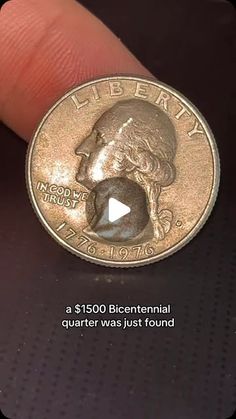 a coin with the image of george washington on it is being held by someone's finger