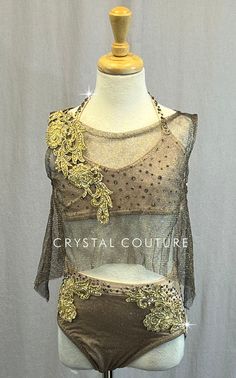 This unique custom costume is full of beautiful details. Starting with Nude lycra as the base for the bra top and trunks then an added metallic Gold and Brown mesh cropped tunic top, with solid rhinestoned Gold floral applique at the shoulder. Trunks also covered in Gold metallic and brown mesh with Gold rhinestoned appliques following the seams all the way around. This costume has over 9 gross of rhinestones in Light Peach, Greige and Crystal Silver Shade and was beautifully constructed in ever Fitted Gold Sets For Costume Party, Festival Embellished Fitted Choli, Fitted Embellished Choli For Festival, Embellished Fitted Festival Sets, Fitted Embellished Sets For Festivals, Embellished Fitted Sets For Festival, Fitted Belly Dance Sets For Party, Trio Costumes, Sequin Jewelry