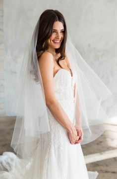 a woman wearing a wedding dress and veil