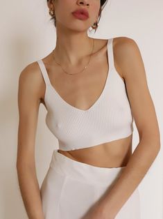 White ribbed sweater bralette top featuring a deep v neckline and a cropped bra length. Style with a pair of boxer shorts and oversized button-up for an easy summer casual look. 65% Viscose 45% Nylon S (2-4), M (6-8), L (10-12) Imported Trendy Crop Top With Built-in Bra For Loungewear, Low-cut Crop Top With Built-in Bra For Loungewear, Low-cut Tops With Built-in Bra For Loungewear, Trendy Seamless V-neck Crop Top, Seamless Low-cut Crop Top For Loungewear, Seamless V-neck Crop Top For Day Out, V-neck Crop Top With Built-in Bra For Beach, Trendy Seamless Crop Top For Loungewear, Cropped Loungewear Crop Top With Built-in Bra