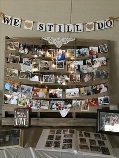 a table topped with pictures and photos next to a sign that says we still do