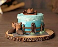 a blue cake with cowboy boots and booties on it