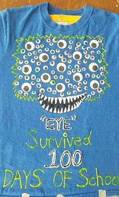 a blue t - shirt with an eye covered 100 days of school on it