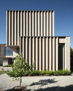 an exterior view of a building with vertical lines on the facade