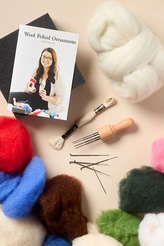 wool, knitting needles, and other crafting supplies laid out on a table