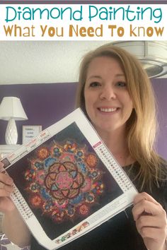 a woman is holding up a book with an image of a flower on it and the title, diamond painting what you need to know