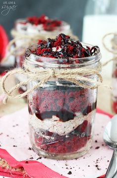 red velvet dessert in a jar with spoons on the side and napkin underneath it