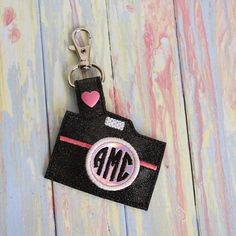 a keychain with the word monogrammed on it and a pink heart