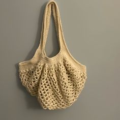 a crocheted bag hanging on the wall