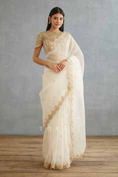 Ivory saree with dori, sequin embroidery in floral pattern and mughal border. Components: 1 Pattern: Embroidery Type Of Work: Dori, sequin, floral Fabric: Silk Organza Color: Ivory Other Details:  Mughal border Cutwork hem Note: Blouse worn by the model is not for sale Occasion: Wedding - Aza Fashions Mughal Border, Ivory Saree, Saree For Women, Kurti Designs Party Wear, Sequin Embroidery, Draped Skirt, Fancy Blouses, Embroidery Designs Fashion, Ivory Silk