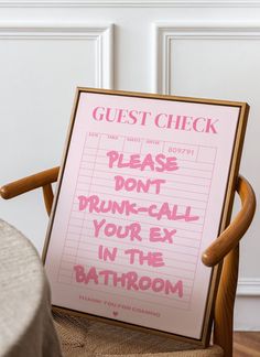 a guest check sign sitting on top of a wooden chair next to a table with a cloth