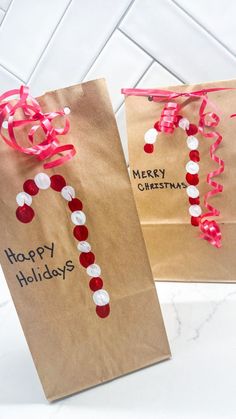 two brown paper bags decorated with red and white candy canes