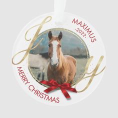 a christmas ornament with a horse and red ribbon on the bottom that says mammas merry christmas