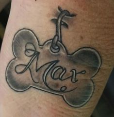 a tattoo on the leg of a person with a dog bone