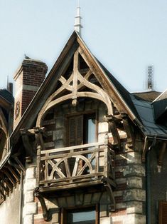 an old building with a clock tower on the top of it's roof and balconies