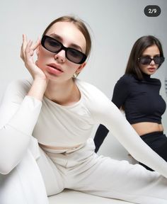 two women in black and white are posing for the camera