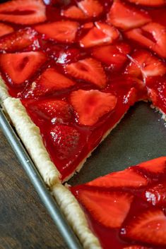 a strawberry slab pie is cut into slices