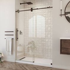 a bathroom with white walls and wood flooring next to a mirror on the wall