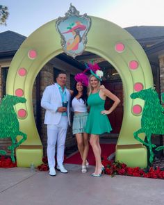 two women and a man standing in front of a sign for disney's princess