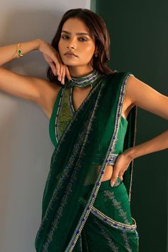 Green pre-draped saree with hamsa pattern, highlighted with beads and cutdana embellishments. Paired with a padded, halter neck blouse with cutdana and crystal embellishments.
Components: 2
Type Of Work: Hamsa
Neckline: Halter Neck
Sleeve Type: Sleeveless
Fabric: Chiffon
Color: Green
Other Details: 
Padded blouse
Attached inner lining
Occasion: Sangeet - Aza Fashions Hamsa Pattern, Halter Neck Blouse, Halter Neck Blouses, Draped Saree, Padded Blouse, Drape Saree, Types Of Work, Blouse For Women, Saree With Blouse